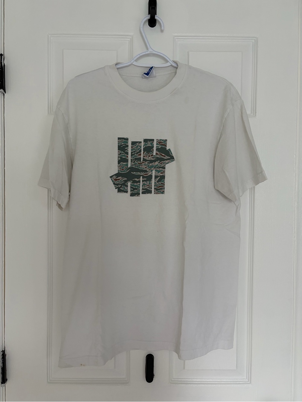 Undefeated Cream Short Sleeve Tee with Green Graphic